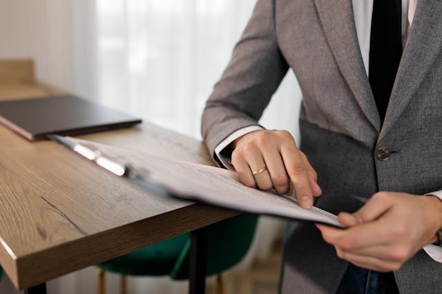 person-reading-documents-on-a-clipboard