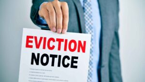 person holding up and eviction notice with the word eviction in red