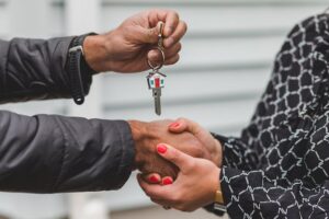 two people shaking hands as they exchange house keys