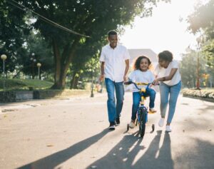 A happy family in a neighborhood.