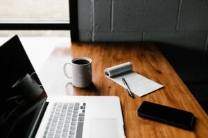 Table-with-computer-coffee-cup-and-notepad.